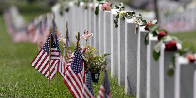 Flags and roses decorate graves in Section 60, where many members of the military killed in Iraq and Afghanistan are buried, during Memorial Day observances at Arlington National Cemetery in Arlington, Virginia, May 27, 2013. REUTERS/Jonathan Ernst (UNITED STATES - Tags: POLITICS MILITARY)