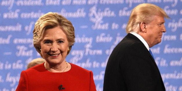 TOPSHOT - Democratic nominee Hillary Clinton (L) and Republican nominee Donald Trump leave the stage after the first presiden