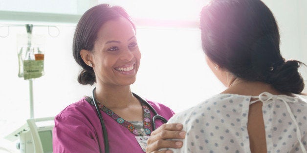 Nurse talking to patient in hospital room