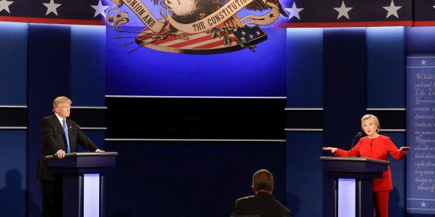 Democratic presidential nominee Hillary Clinton answers a question as Republican presidential nominee Donald Trump listens during the presidential debate at Hofstra University in Hempstead, N.Y., Monday, Sept. 26, 2016. (AP Photo/David Goldman)