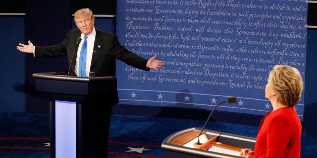 Republican U.S. presidential nominee Donald Trump speaks as Democratic U.S. presidential nominee Hillary Clinton listens duri