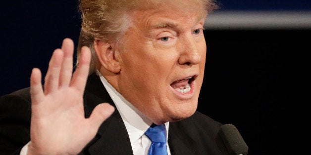 Republican presidential nominee Donald Trump answers a question during the presidential debate with Democratic presidential n