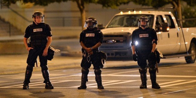 CHARLOTTE, NORTH CAROLINA, USA - SEPTEMBER 25: Police officers stand guard in front of Central Piedmont Community College during a demonstration following the shooting of Keith Lamont Scott, 43, shot and killed by police officers at an apartment complex near UNC Charlotte, in Charlotte, North Carolina, USA on September 25, 2016. (Photo by Peter Zay/Anadolu Agency/Getty Images)