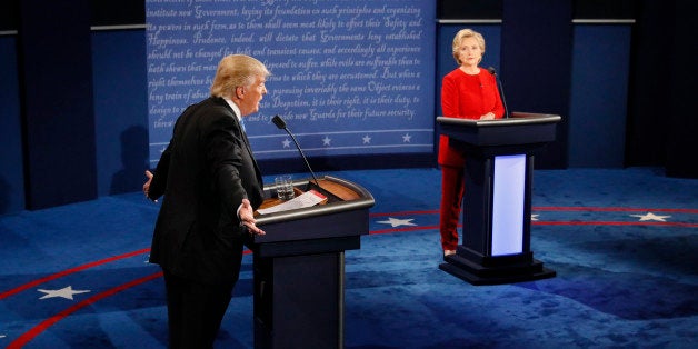 Republican U.S. presidential nominee Donald Trump speaks as Democratic U.S. presidential nominee Hillary Clinton listens duri