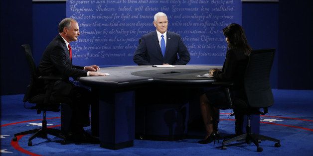 Tim Kaine, 2016 Democratic vice presidential nominee, from left, Mike Pence, 2016 Republican vice presidential nominee, and moderator Elaine Quijano sit during the vice presidential debate at Longwood University in Farmville, Virginia, U.S., on Tuesday, Oct. 4, 2016. Indiana Governor Mike Pence and Virginia Senator Tim Kaine arrive at tonight's debate with three main assignments: defend their bosses from attack, try to land a few blows, and avoid any mistakes showing them unfit to be president. Photographer: Andrew Harrer/Bloomberg via Getty Images