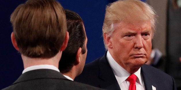 Republican U.S. presidential nominee Donald Trump passes by passes his sons Donald Jr. and Eric (L) at the conclusion of the