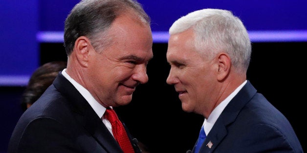 Democratic U.S. vice presidential nominee Senator Tim Kaine (L) and Republican U.S. vice presidential nominee Governor Mike Pence pass each other on stage at the conclusion of their vice presidential debate at Longwood University in Farmville, Virginia, U.S., October 4, 2016. REUTERS/Kevin Lamarque 