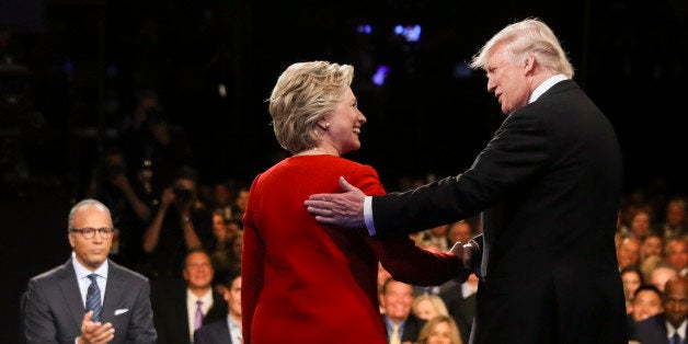 FILE - In this Sept. 26, 2016 file photo, Democratic presidential nominee Hillary Clinton and Republican presidential nominee Donald Trump shake hands during the presidential debate at Hofstra University in Hempstead, N.Y. For presidential candidates, the town hall debate is a test of stagecraft as much as substance. When Hillary Clinton and Donald Trump meet in the Sunday, Oct.9, 2016, contest, theyâll be fielding questions from undecided voters seated nearby. In an added dose of unpredictability, the format allows the candidates to move around the stage, putting them in unusually close proximity to each other. (Joe Raedle/Pool via AP, File)