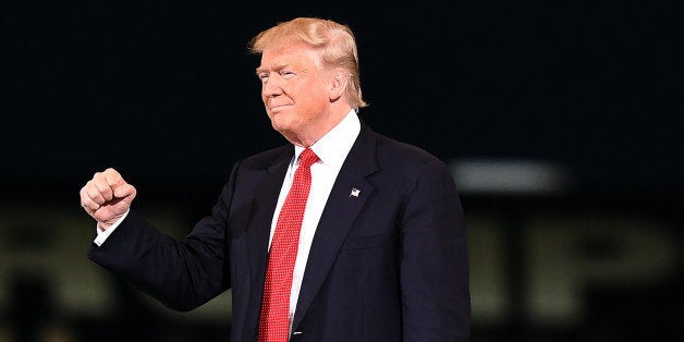 US Republican presidential nominee Donald Trump gestures at supporters during a campaign rally at the Orlando Melbourne International Airport in Melbourne, Florida, on September 27, 2016. / AFP / Jewel SAMAD (Photo credit should read JEWEL SAMAD/AFP/Getty Images)