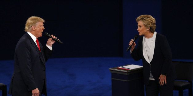 Donald Trump, 2016 Republican presidential nominee, and Hillary Clinton, 2016 Democratic presidential nominee, speak during the second U.S. presidential debate at Washington University in St. Louis, Missouri, U.S., on Sunday, Oct. 9, 2016. As has become tradition, the second debate will resemble a town hall meeting, with the candidates free to sit or roam the stage instead of standing behind podiums, while members of the audience -- uncommitted voters, screened by the Gallup Organization -- will ask half the questions. Photographer: Andrew Harrer/Bloomberg via Getty Images