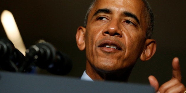 U.S. President Barack Obama (L) takes the stage to deliver remarks at a senatorial campaign fundraiser event for U.S. Represe
