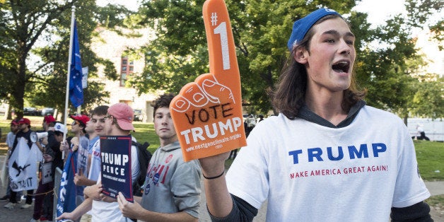 Protesters supporting Donald Trump, 2016 Republican presidential nominee, stand outside of a campaign event for Hillary Clint
