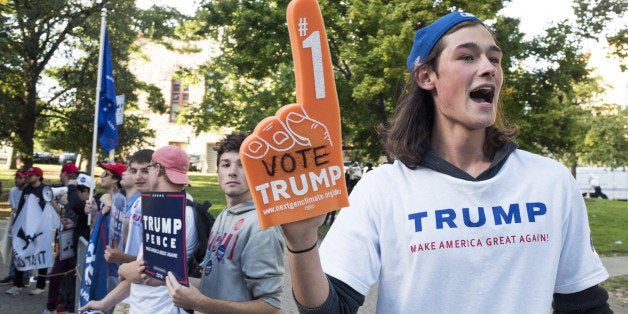 Protesters supporting Donald Trump, 2016 Republican presidential nominee, stand outside of a campaign event for Hillary Clinton, 2016 Democratic presidential nominee, in Columbus, Ohio, U.S., on Monday, Oct. 10, 2016. Clinton and Donald Trump combined salacious charges about past sexual scandals with sober discussion of substantive topics during their second presidential debate Sunday night following a weekend of unprecedented crisis in the Republican nominee's campaign. Photographer: Ty Wright/Bloomberg via Getty Images