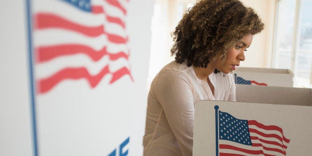 Young woman preparing voting booth