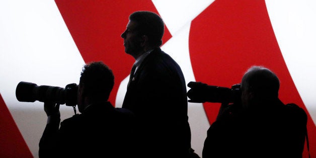 Photographers train their lenses on the stage during the second presidential town hall debate between Republican U.S. presidential nominee Donald Trump and Democratic U.S. presidential nominee Hillary Clinton at Washington University in St. Louis, Missouri, U.S., October 9, 2016. REUTERS/Aaron P. Bernstein 