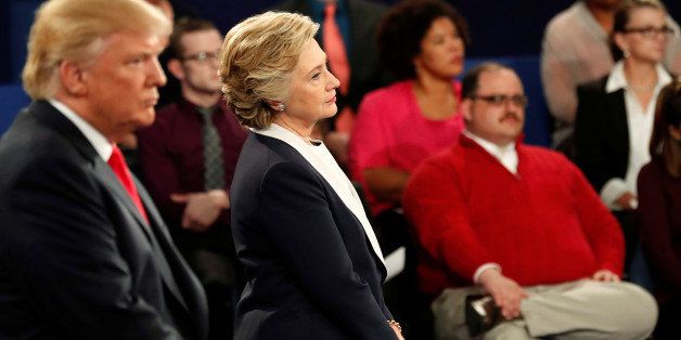 Ken Bone (R), a power plant employee from Belleville, Illinois, listens to a question along with Republican U.S. presidential nominee Donald Trump (L) and Democratic nominee Hillary Clinton (C) during their presidential debate at Washington University in St. Louis, Missouri, U.S., October 9, 2016. Picture taken October 9, 2016. REUTERS/Rick Wilking