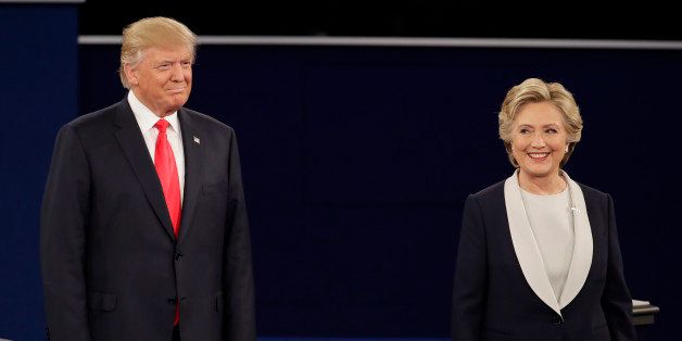 Republican presidential nominee Donald Trump stands next to Democratic presidential nominee Hillary Clinton during the second presidential debate at Washington University in St. Louis, Sunday, Oct. 9, 2016. (AP Photo/Julio Cortez)