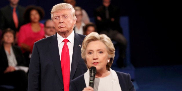 Republican U.S. presidential nominee Donald Trump listens as Democratic nominee Hillary Clinton answers a question from the a