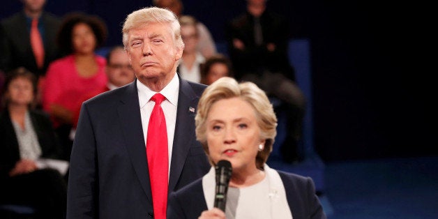 Republican U.S. presidential nominee Donald Trump listens as Democratic nominee Hillary Clinton answers a question from the audience during their presidential town hall debate at Washington University in St. Louis, Missouri, U.S., October 9, 2016. REUTERS/Rick Wilking TPX IMAGES OF THE DAY 