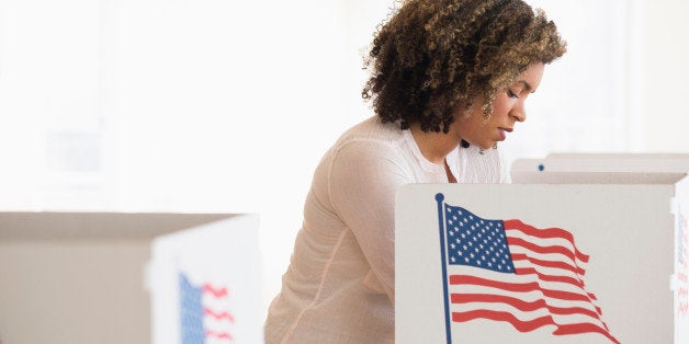 Young woman preparing voting booth