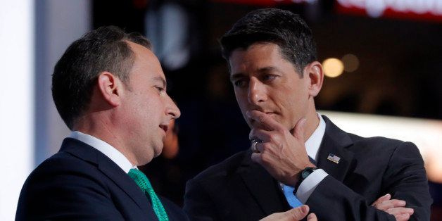 Republican National Committee Chairman Reince Priebus (L) and Speaker of the House and Chairman of the convention Paul Ryan confer on what to do after the Alaska delegation demanded that their votes for candidates other than Donald Trump be counted and recorded at the Republican National Convention in Cleveland, Ohio, U.S. July 19, 2016. REUTERS/Brian Snyder 