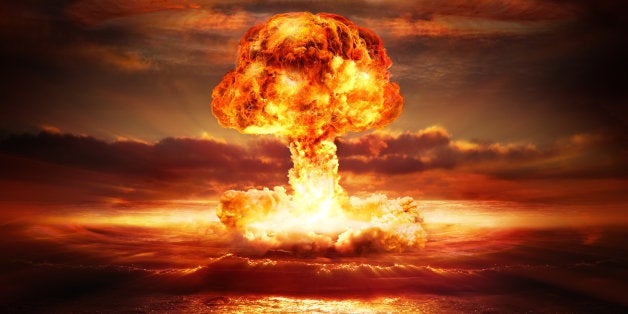 testing of atomic bomb over ocean with mushroom clouds - red destroy