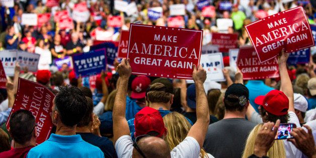 AKRON, OH - AUGUST 22: Supporters hold up signs during a campaign rally of Republican presidential nominee Donald Trump at the James A. Rhodes Arena on August 22, 2016 in Akron, Ohio. Trump currently trails Democratic Presidential candidate Hillary Clinton in Ohio, a state which is critical to his election bid. (Photo by Angelo Merendino/Getty Images)