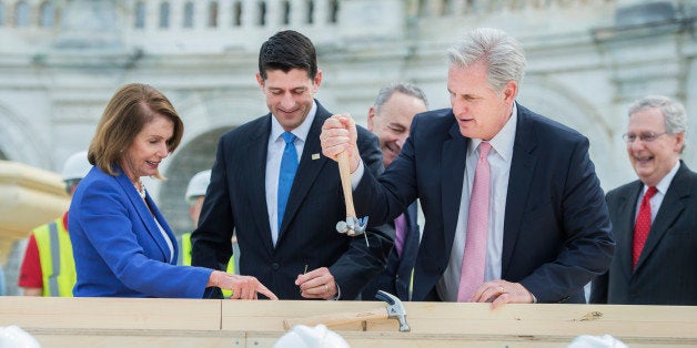 UNITED STATES - SEPTEMBER 21: House Majority Leader Kevin McCarthy, R-Calif., pulls the bent nail of Sen. Charles Schumer, D-N.Y., center, as Speaker Paul Ryan, R-Wis., second from left, Senate Majority Leader Mitch McConnell, R-Ky., and House Minority Leader Nancy Pelosi, D-Calif., look on, during a First Nail Ceremony that launches the construction of the Inaugural platform on the West Front of the Capitol, September 21, 2016. Sen. Roy Blunt, R-Mo., chairman of the Joint Congressional Committee on Inaugural Ceremonies, and Architect of the Capitol Stephen Ayers also participated. The next President will take the oath of office, January 20, 2017. (Photo By Tom Williams/CQ Roll Call)