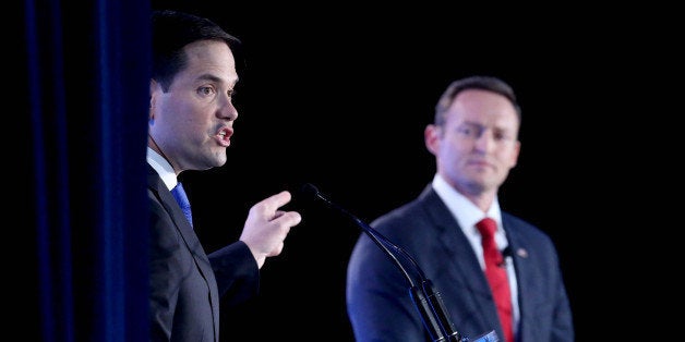 Republican Sen. Marco Rubio makes a point as Democratic challenger Rep. Patrick Murphy listens during the U.S. Senate debate