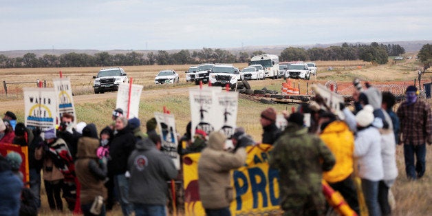 Dakota Access Pipeline protesters square off against police between near Standing Rock Reservation and the pipeline route out