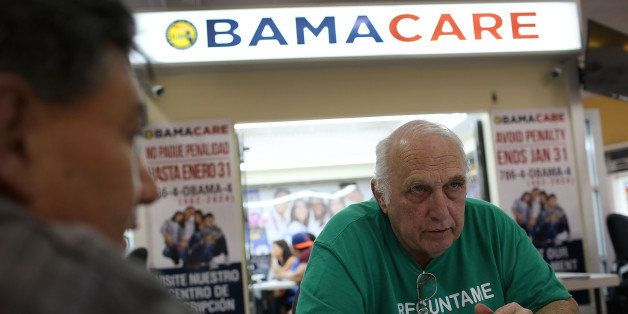 MIAMI, FL - NOVEMBER 02: Antonio Galis, an insurance agent from Sunshine Life and Health Advisors, discusses with a client plans available in the third year of the Affordable Care Act at a store setup in the Mall of the Americas on November 2, 2015 in Miami, Florida. Open Enrollment began yesterday for people to sign up for a 2016 insurance plan through the Affordable Care Act. (Photo by Joe Raedle/Getty Images)