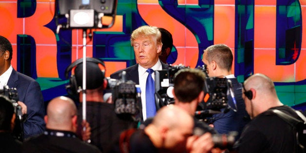 Republican U.S. presidential candidate Donald Trump is surrounded by TV technicians and cameras at the conclusion of the debate sponsored by CNN for the 2016 Republican U.S. presidential candidates in Houston, Texas, February 25, 2016. REUTERS/Mike Stone 