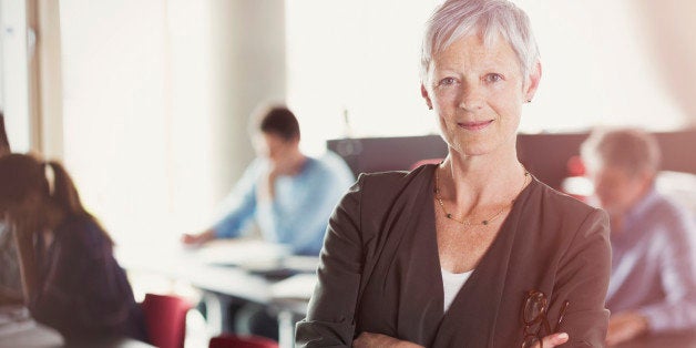 Portrait of confident senior woman in adult education classroom