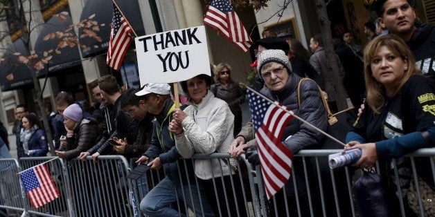 People watch as the Veterans' Day parade makes its way up 5th Avenue in New York November 11, 2015. REUTERS/Shannon Stapleton