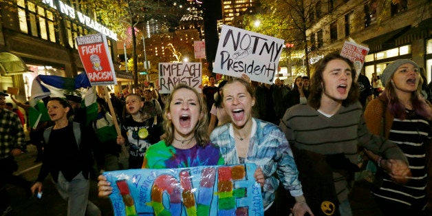 Protesters chant and hold signs during a protest against the election of President-elect Donald Trump, Wednesday, Nov. 9, 2016, in downtown Seattle. (AP Photo/Ted S. Warren)