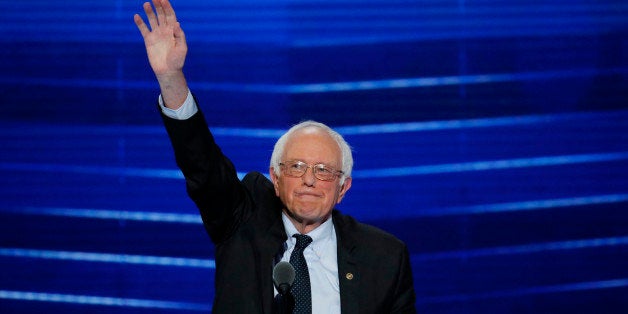 Former Democratic presidential candidate, Sen. Bernie Sanders, I-Vt., waves to the delegates before addressing the first day