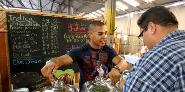 Grower Anthony Nguyen sells marijuana at the medical marijuana farmers market at the California Heritage Market in Los Angeles, California July 11, 2014. REUTERS/David McNew/File Photo