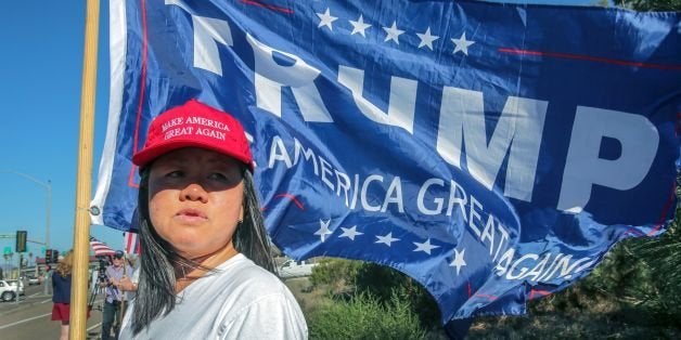 Ly Kou joins supporters of US President-elect Donald Trump during a street-side rally in front of Marine Corps Base Camp Pendleton in Oceanside, California, on November 11, 2016. / AFP / Bill Wechter (Photo credit should read BILL WECHTER/AFP/Getty Images)