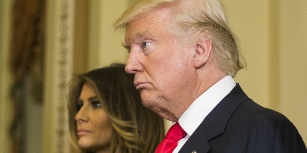 WASHINGTON, USA - NOVEMBER 10: U.S. President-elect Donald Trump, with his wife Melania (L), speaks after meeting with Senate Majority Leader Mitch McConnell two days after winning the 2016 Presidential Election in Washington, USA on November 10, 2016. (Photo by Samuel Corum/Anadolu Agency/Getty Images)