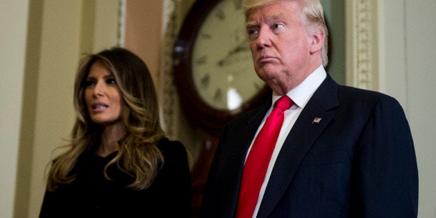 UNITED STATES - NOVEMBER 10: President-elect Donald Trump, takes a few questions from the press as he leaves with his wife Melania Trump escorted by Senate Majority Leader Mitch McConnell, R-Ky., (not pictured) after their meeting in Leader McConnell's office in the U.S. Capitol on Thursday, Nov. 10, 2016. (Photo By Bill Clark/CQ Roll Call)