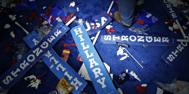 A worker walks past a 'Hillary' sign on the floor after the Democratic National Convention (DNC) in Philadelphia, Pennsylvani