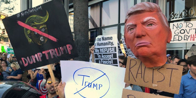 Protesters hold banners during a rally outside the CNN studios, in opposition to President-elect Donald Trump, in the Hollywo