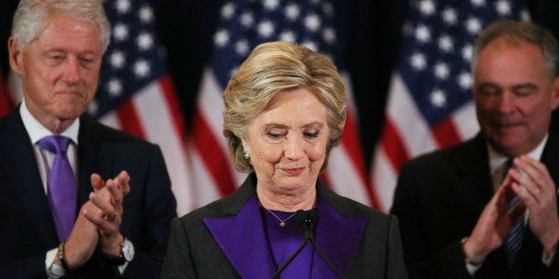 Hillary Clinton, accompanied by her husband former U.S. President Bill Clinton (L) and running mate Senator Tim Kaine, addres