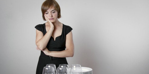 Worried woman setting the table for a celebration day