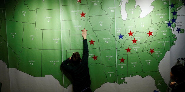 A man marks a star on the Electoral College Map during a U.S. Election Watch event hosted by the U.S. Embassy at a hotel in S