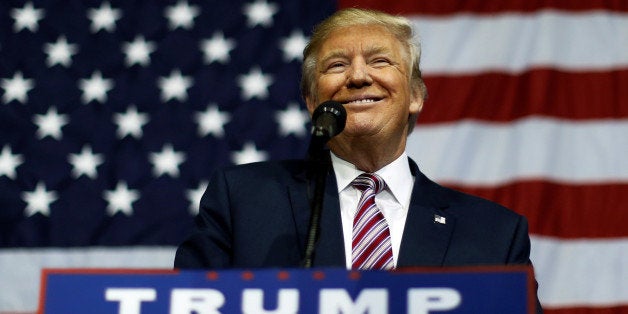 U.S. Republican presidential nominee Donald Trump smiles after making what he said was a major announcement, that he'd abide