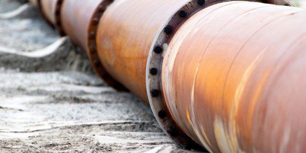 Corroded pipelines, used for land reclamation, on a beach. Holland