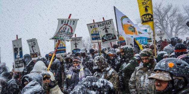 OCETI SAKOWIN CAMP, CANNONBALL, NORTHDAKOTA, UNITED STATES - 2016/12/05: Winter has arrived in Standing Rock at the Oceti Sakowin Camp in North Dakota, the day after the Army Corps of Engineers denied the easement needed to build the pipeline. Despite driving snow and 40-plus mile an hour wind a group of 700-plus veterans and water protectors marched toward the barricade on highway 1806. (Photo by Michael Nigro/Pacific Press/LightRocket via Getty Images)