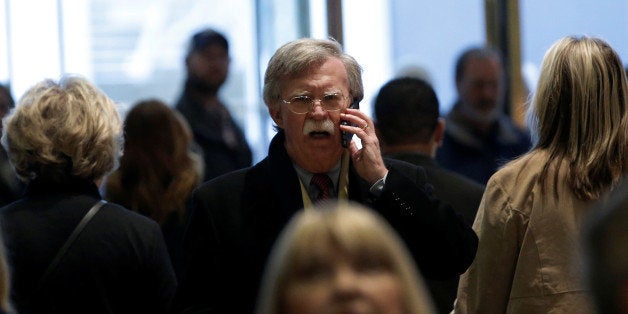 Former U.S. Ambassador to the United Nations John Bolton speaks on a mobile phone as he arrives for a meeting with U.S. Presi