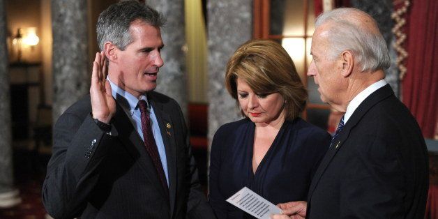 New US Senator Scott Brown (L) with his wife Gail Huff (C) is sworn-in in the Old Senate Chamber by US Vice President Joe Biden on February 4, 2010 inside the US Capitol in Washington, DC. AFP PHOTO / Tim Sloan (Photo credit should read TIM SLOAN/AFP/Getty Images)